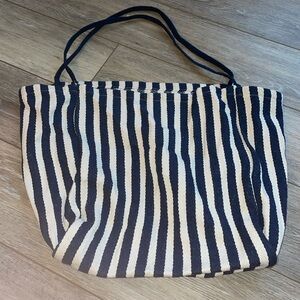 Canvas tote. Open with no closure or pockets. Great reusable shopping bag!